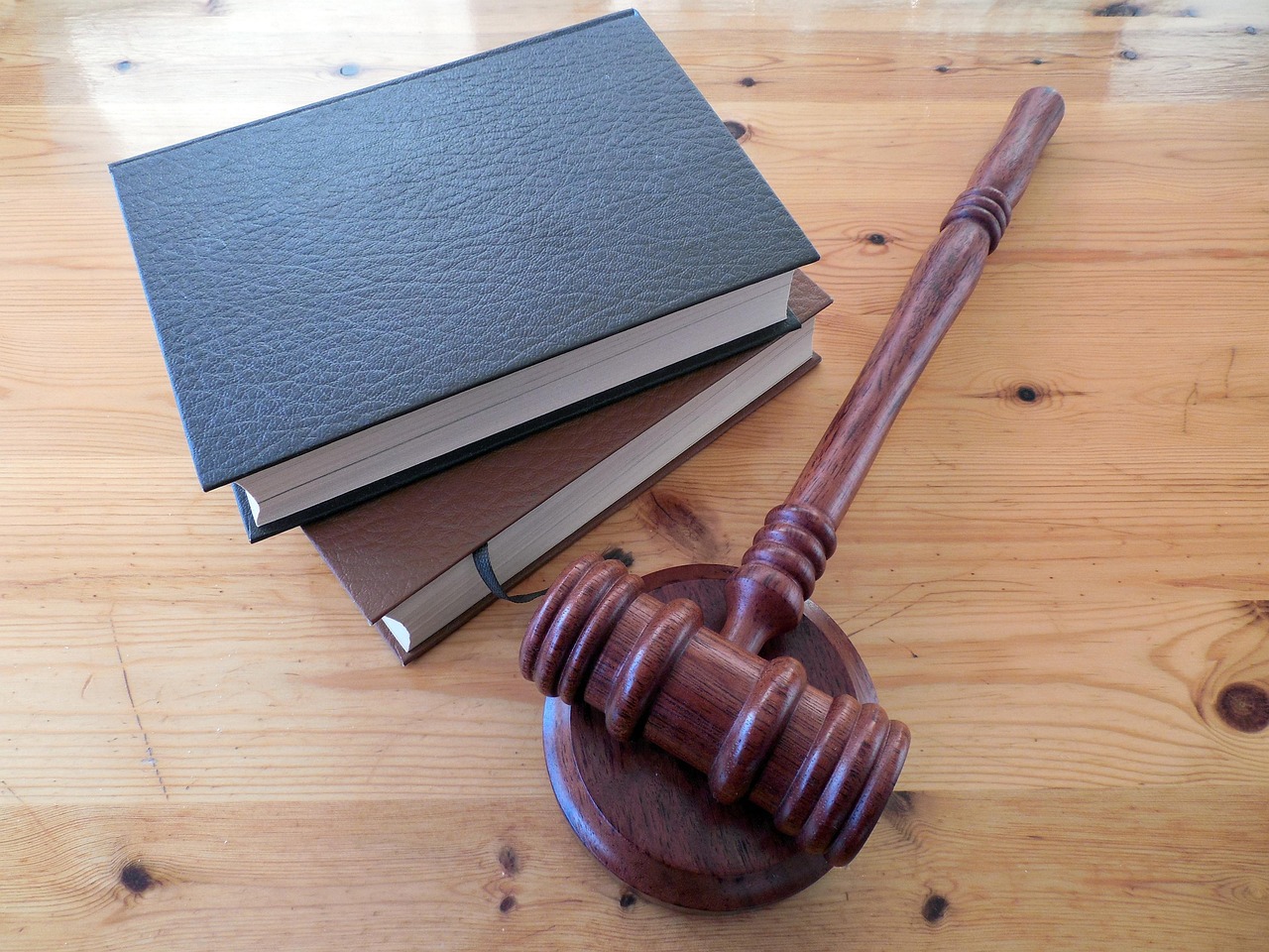 gavel on top of an open law book with binary code projection