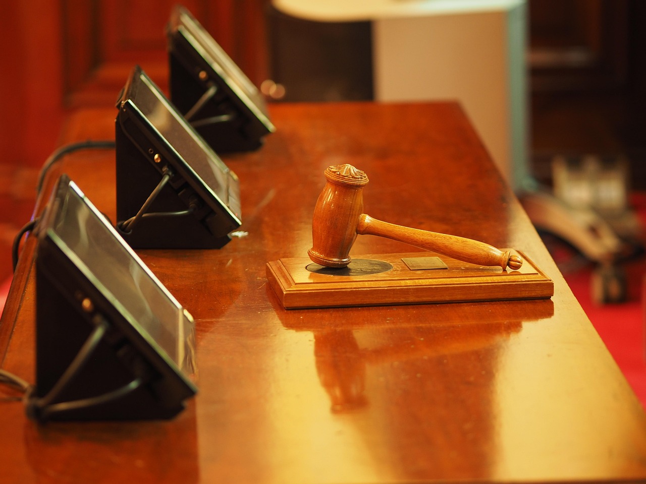judiciary gavel next to futuristic glowing circuit board