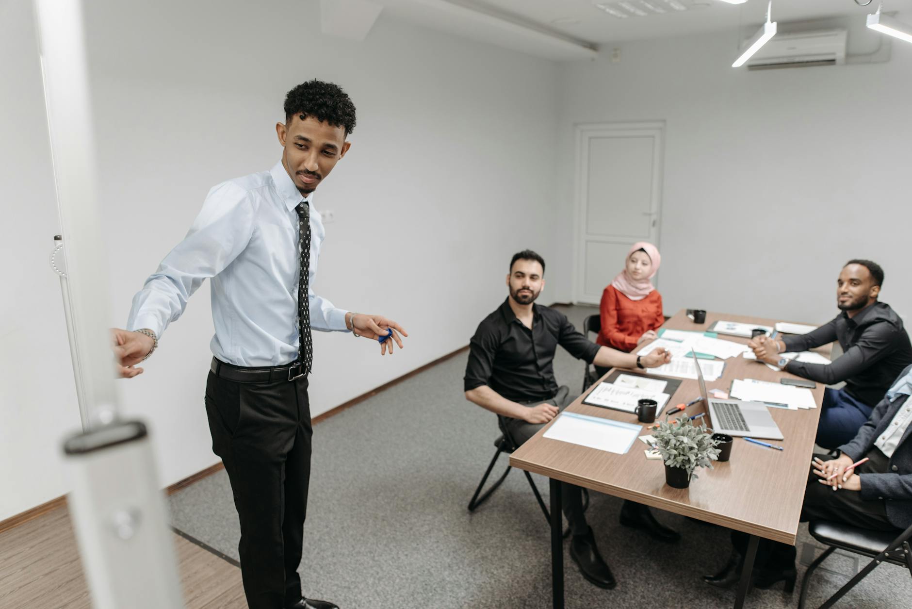 A diverse team collaborates in a modern office setting, showcasing teamwork and communication.