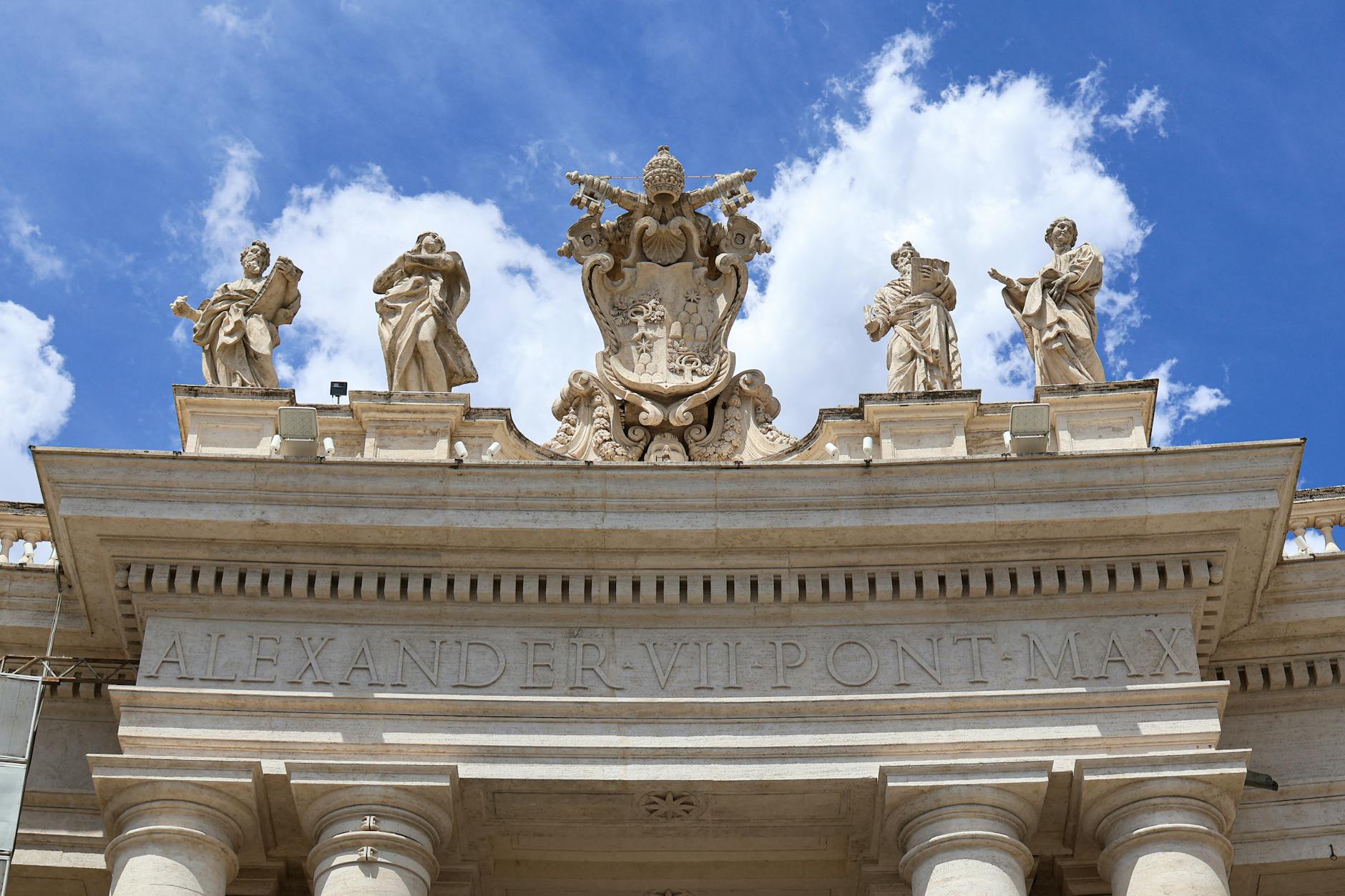 Close-up of statues and architecture at St. Peter's Basilica, Vatican City under a clear blue sky.