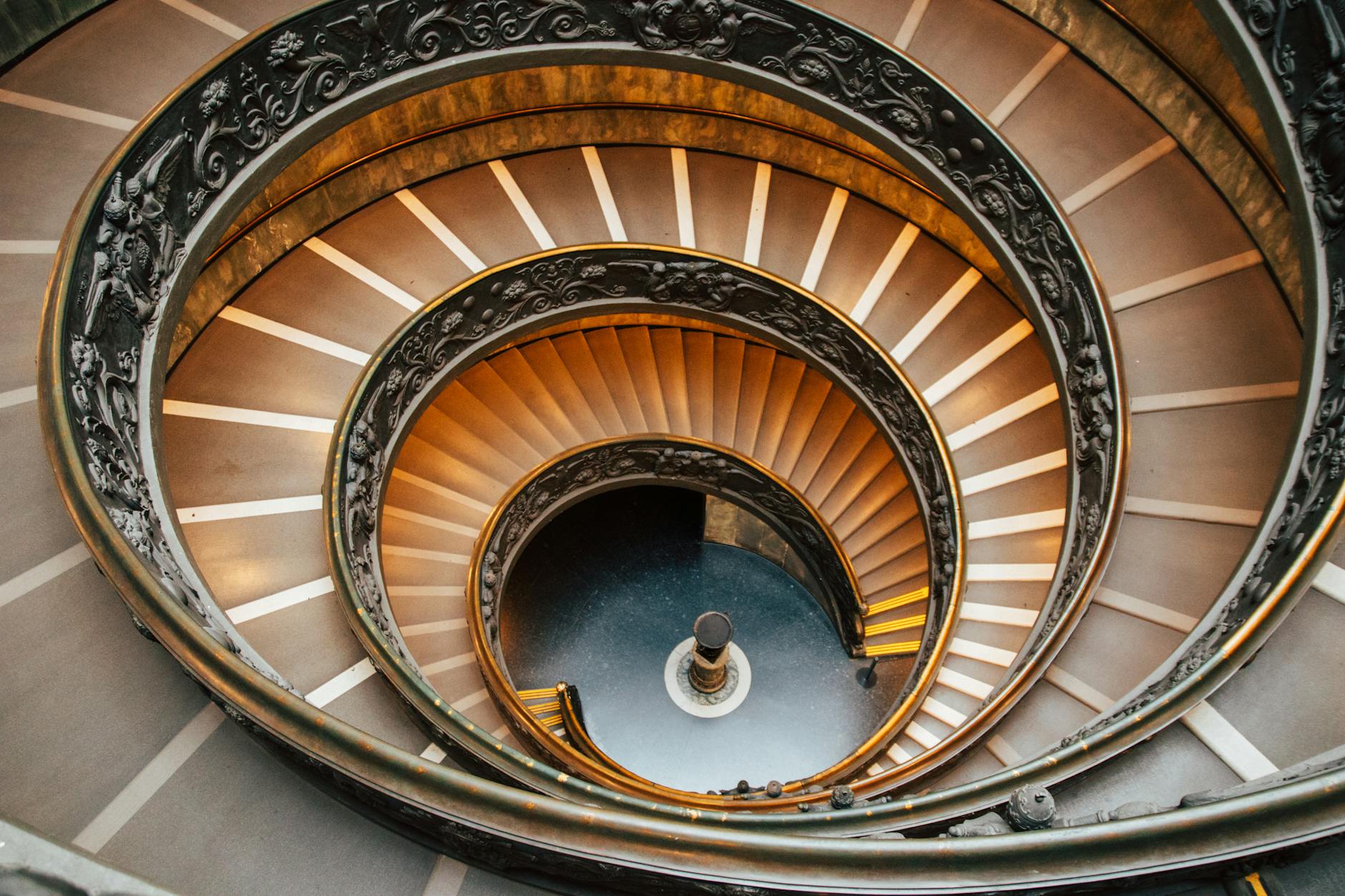 Dramatic view of the iconic spiral staircase in Vatican Museums, Vatican City, showcasing its architectural elegance.