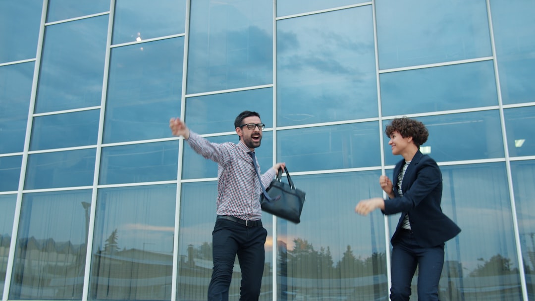 Professional business team interacting with holographic AI analytics in modern glass office, futuristic corporate dashboard displays, warm ambient lighting, human-technology collaboration moment