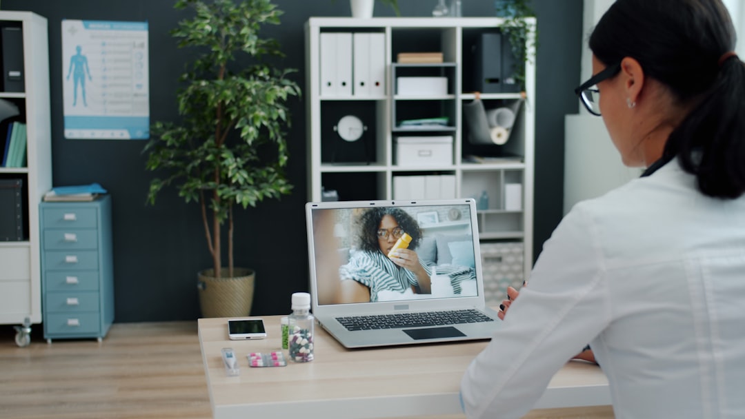 Medical AI dashboard displaying concrete patient data charts with doctor pointing at holographic interface in modern hospital