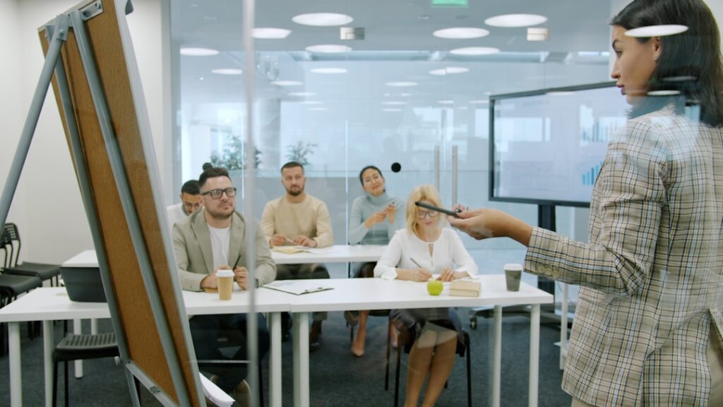 Futuristic classroom with holographic displays showing personalized learning paths, diverse students wearing sleek AR glasses, ambient blue lighting, neural network visualization floating above desks,