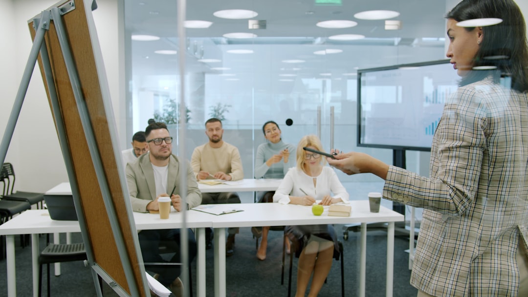 Futuristic classroom with holographic displays showing personalized learning paths, diverse students wearing sleek AR glasses, ambient blue lighting, neural network visualization floating above desks,