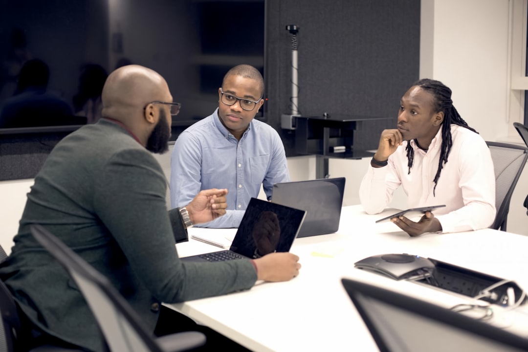 Diverse team of professionals in clean modern office examining holographic medical AI scan, futuristic dashboard with real-time neural network analytics, human-robot collaboration scene, soft ambient 