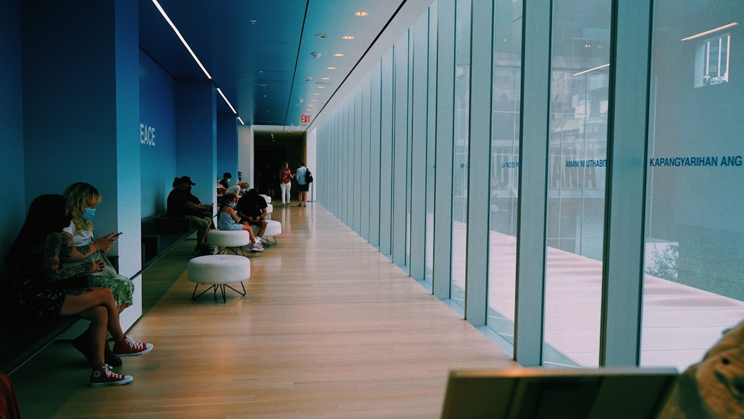 Professional business analyst reviewing AI market growth holographic display, clean modern office with glass walls, ambient sunset lighting, data charts transforming into real gold coins, sleek minima