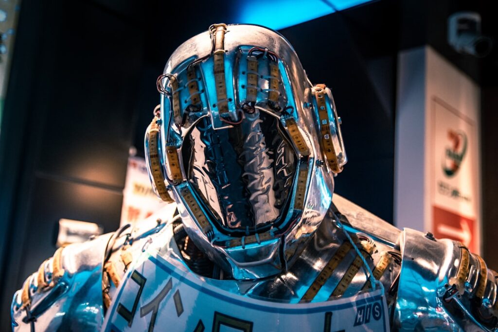 Futuristic AI researcher in sleek glass-walled MIT lab, holographic neural network visualization floating mid-air, ambient blue-white lighting, human-robot collaboration scene, clean modern workspace,
