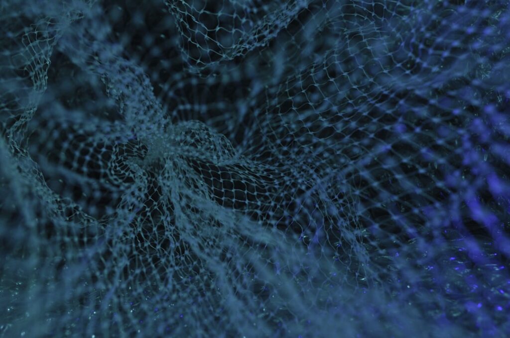 Futuristic neural network visualization with glowing blue nodes and sound wave patterns, holographic microphone, sleek dark studio, ambient cyan lighting, professional tech aesthetic