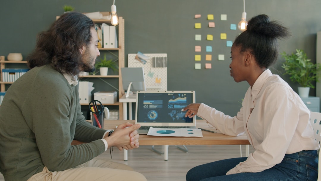 Professional business team analyzing holographic cost reduction graphs in clean modern office, sleek dashboard displays, ambient warm lighting, medical AI application visible, scalable infrastructure 