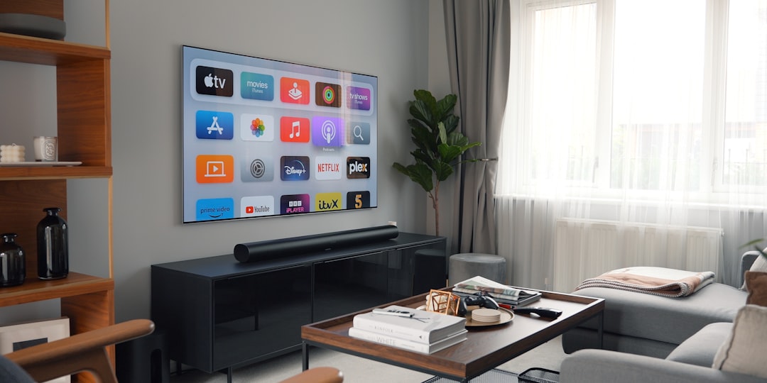 Wide shot of diverse professional using seamless smart home and wearable devices, warm ambient lighting, clean modern living space, holographic notifications floating in air, sleek Apple-style ecosyst