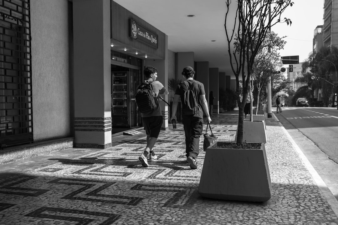 Diverse Brazilian family interacting with sleek medical AI kiosk in modern public health clinic, warm hopeful lighting, holographic health data display, human-centered technology, professional healthc