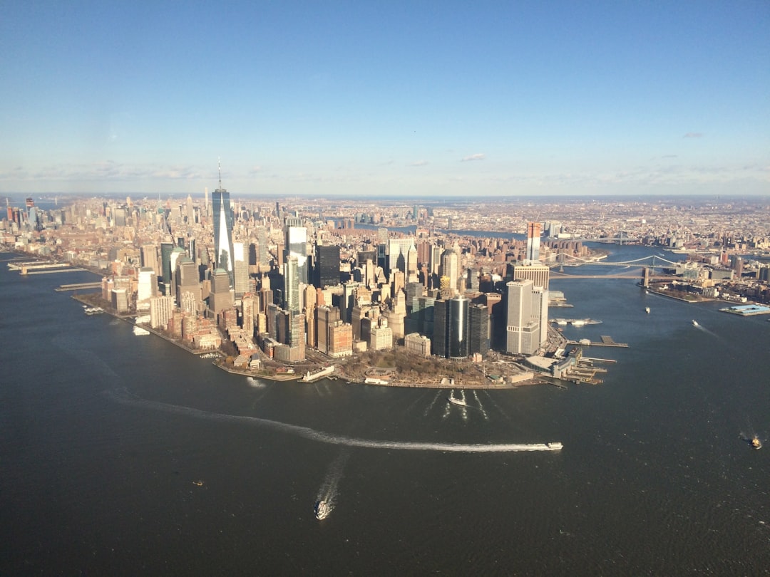 Aerial view of financial district at dusk with holographic IPO data projections, sleek trading floor with ambient screens, professional investor silhouette, neural network visualization merging with c