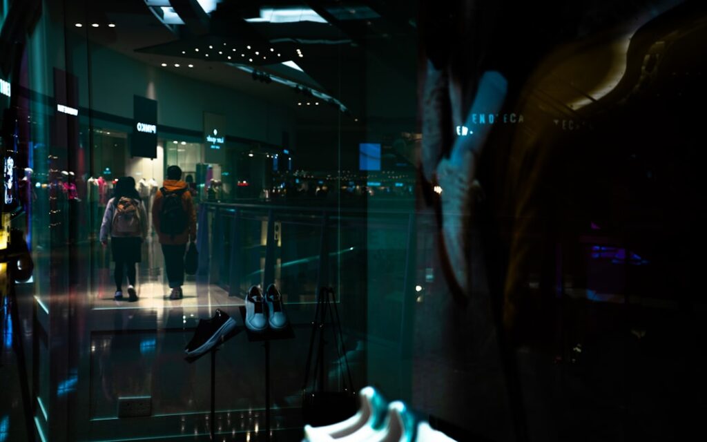 Futuristic robotics lab with diverse engineers collaborating around holographic display, ambient blue lighting, sleek modern workspace, technology innovation and social impact concept