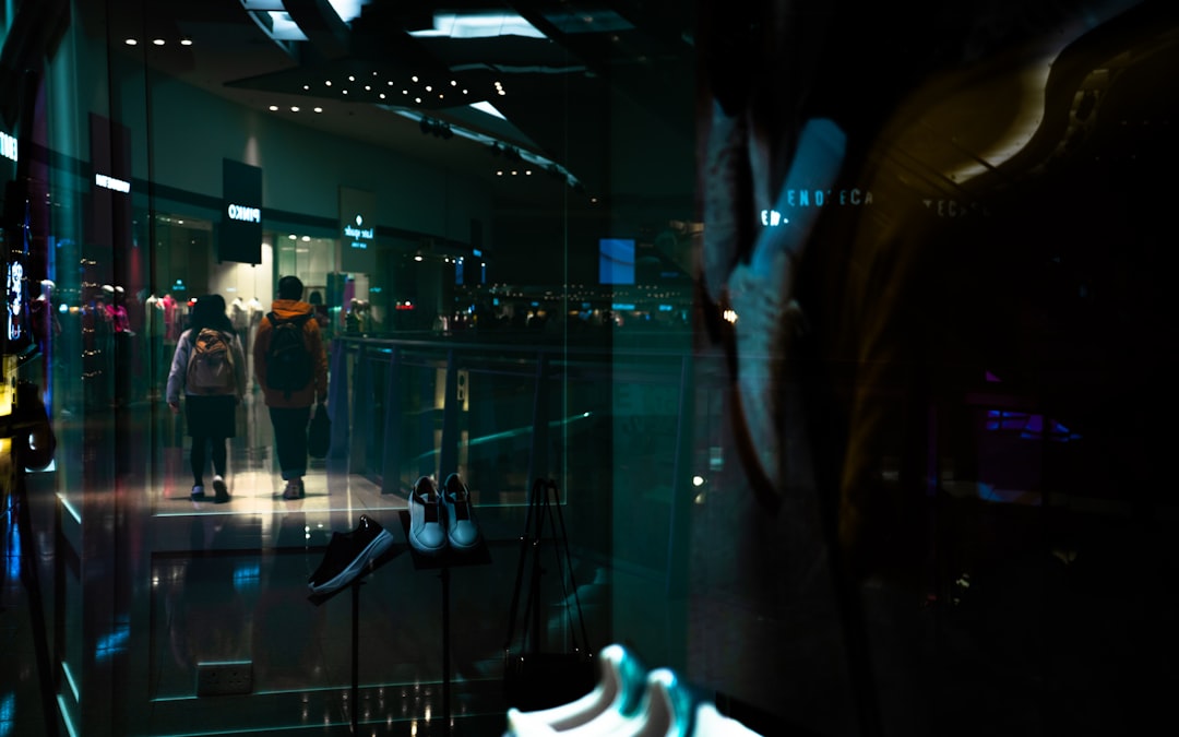 Futuristic robotics lab with diverse engineers collaborating around holographic display, ambient blue lighting, sleek modern workspace, technology innovation and social impact concept