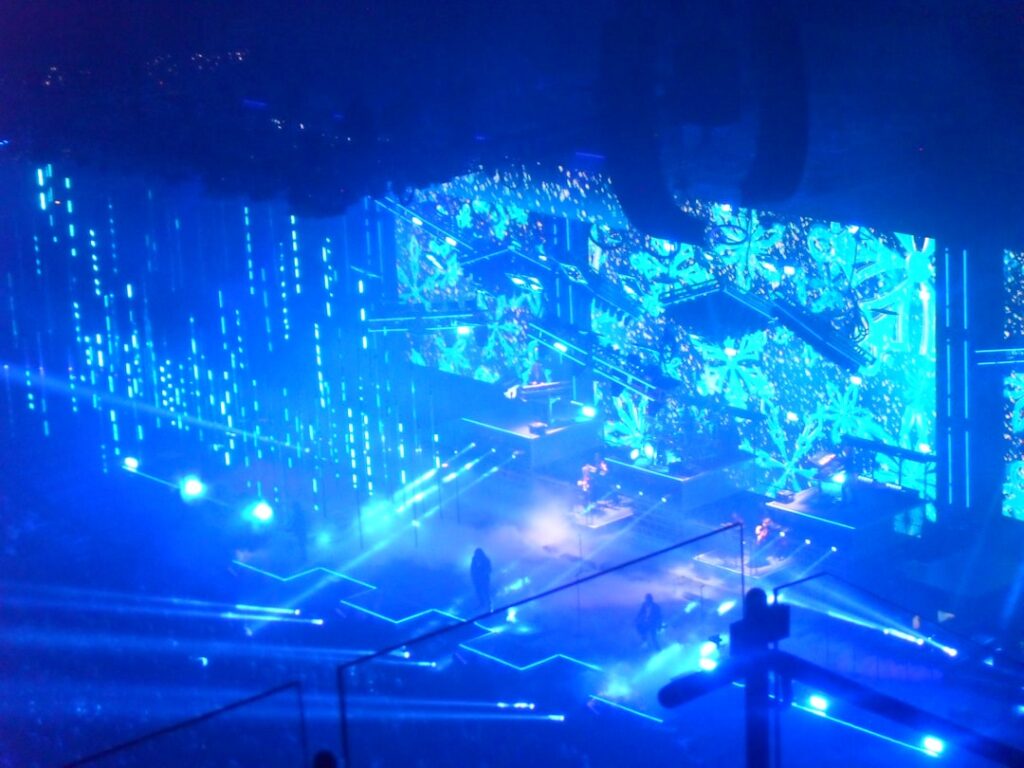 Futuristic military command center with holographic data streams, soldier analyzing glowing tactical maps, sleek blue ambient lighting, neural network overlays, professional defense technology setting