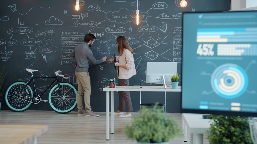 Two businessmen in sleek suits shaking hands in a clean modern office with holographic display of financial charts and ambient blue lighting, symbolizing leadership transition