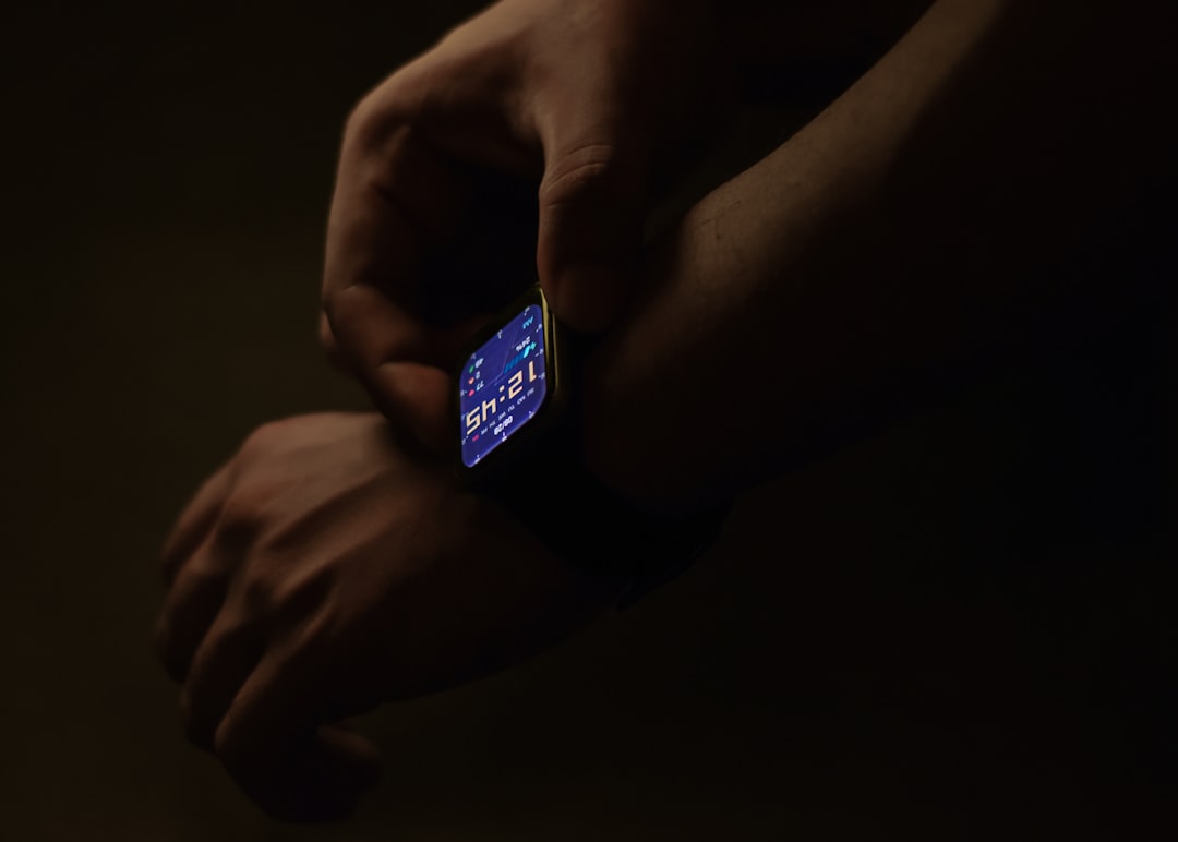 Human-robot collaboration in connected health ecosystem, sleek wearable devices and microchip details, ambient futuristic lighting, diverse medical professionals interacting with holographic patient d
