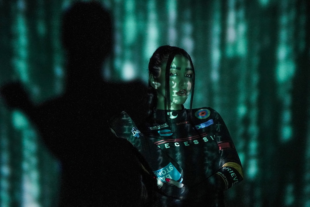 Sleek humanoid robot and professional woman in blazer collaborating at holographic data dashboard, warm amber and cyan lighting, clean modern office, neural network visualization floating between them