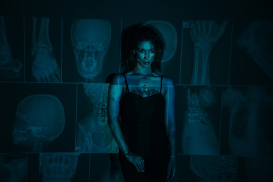 Sleek wearable health tech on diverse patient, AI-generated body scan hologram in clean modern clinic, cool blue ambient lighting, microchip detail on fitness tracker, obesity prevention data dashboar