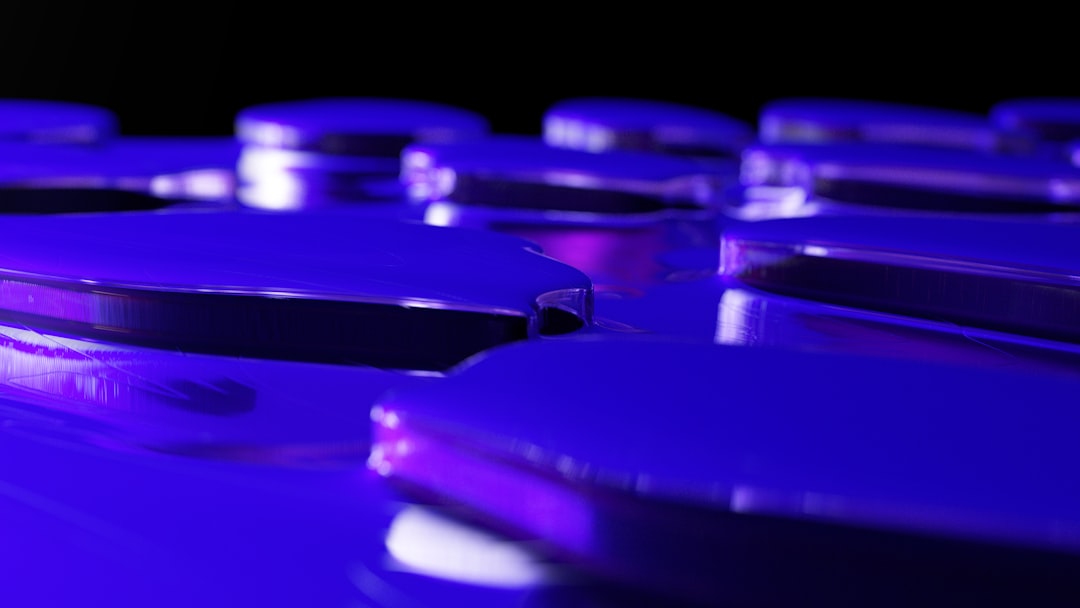 Close-up macro photography of futuristic solid-state battery cell with translucent ceramic electrolyte glowing blue-green, clean laboratory setting with Brazilian researcher in white coat examining ho