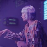 Professional woman in clean modern office hesitantly reaching toward holographic AI interface with glitching neural network visualization, cool ambient lighting, futuristic uncertainty mood