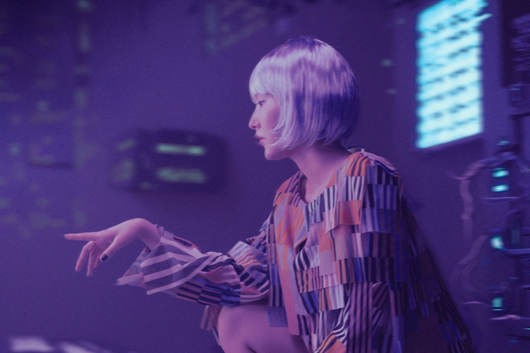 Futuristic professional portrait of a businesswoman interacting with holographic AI agent interface, sleek ambient lighting, clean modern office, neural network visualization floating in mid-air, deep