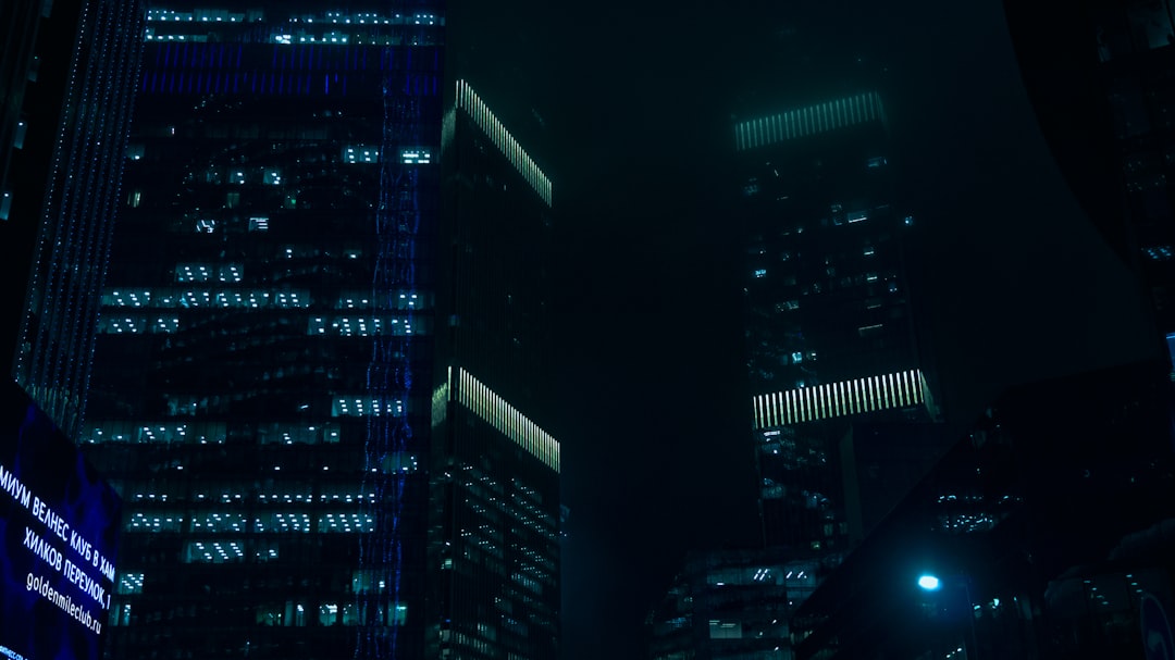 Futuristic data center with glowing dividend payout holograms, professional investor silhouette, sleek blue ambient lighting, neural network overlays, clean modern office setting, technology wealth co