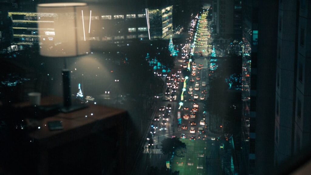 Futuristic AI surveillance dashboard with holographic data visualization in sleek glass office, Latin American city skyline at dusk, ambient blue neon lighting, professional analyst silhouette
