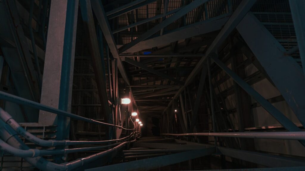 Futuristic abandoned server room with flickering blue lights, overgrown cables, professional tech aesthetic, moody ambient lighting, obsolete technology concept, sleek industrial decay