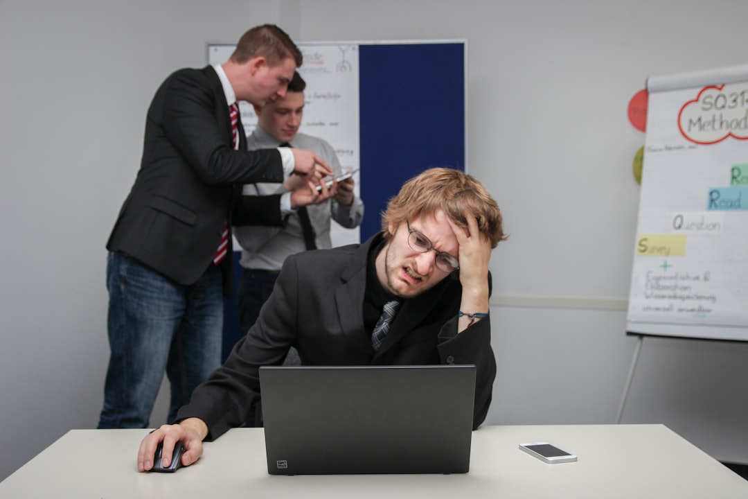 Business executive examining warning signals on futuristic cybersecurity dashboard with red alert holograms in dark server room environment