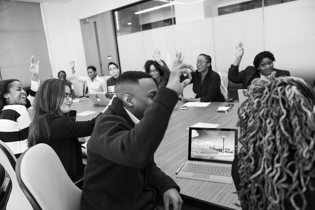 AI ethics concept with diverse professionals gathered around curved cybersecurity dashboard, tense body language, dramatic overhead lighting, holographic governance flowcharts, server room background,