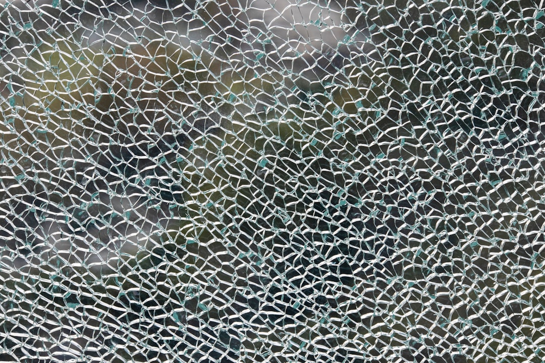Close-up of a cracked holographic display showing Meta AI interface with red warning alerts, dark server room background, blue ambient lighting, cybersecurity concept, professional tech photography