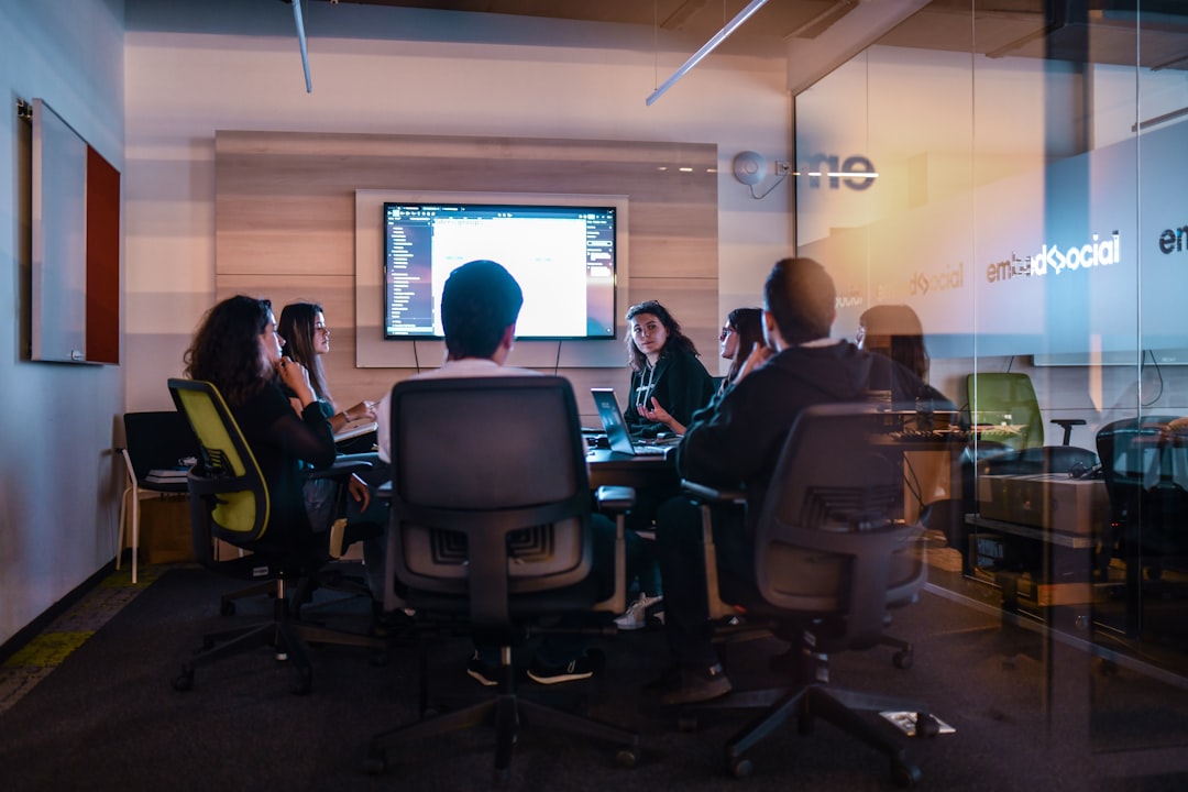 Corporate boardroom with diverse executives examining holographic AI ethics dashboard, sleek glass table, ambient dramatic lighting, data visualization floating mid-air, professional suits, serious co