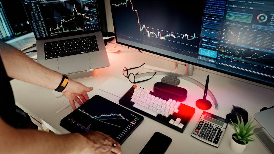 Professional data analyst examining holographic data visualization floating above sleek glass desk, cool cyan and purple tones, modern tech office with server room glow in background