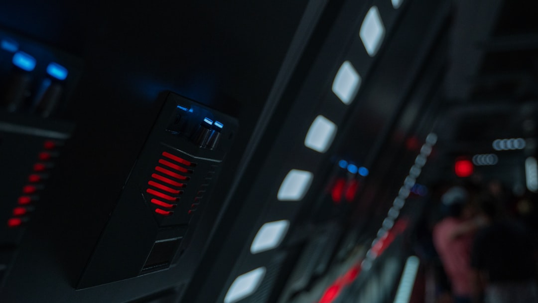 Futuristic industrial AI control room with holographic energy consumption dashboards glowing red, exhausted engineer analyzing power grid overload, dark data center with overheating server racks, dram