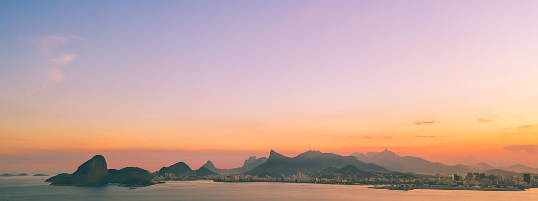 Futuristic Rio de Janeiro skyline at dusk with holographic data overlays, professional business handshake in foreground, sleek ambient lighting, teal and gold color palette, economic growth concept