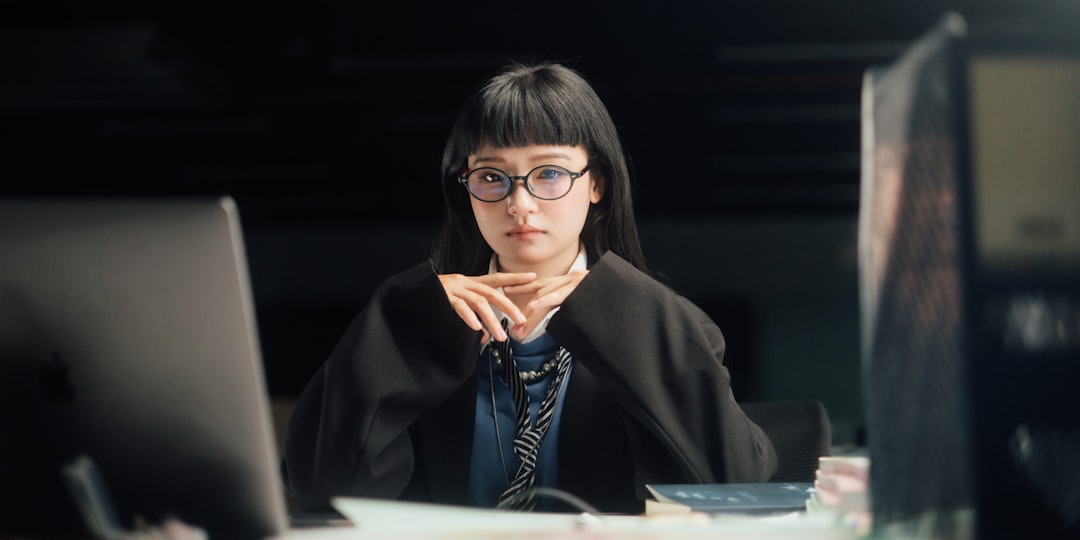 Futuristic AI agent hologram with neural network visualization floating above sleek glass desk, professional woman observing, ambient blue lighting, clean modern office, human-machine collaboration co