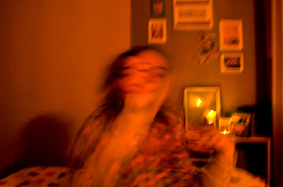 Split composition showing calm person meditating with soft AI companion light versus same person anxiously clutching phone in dark room, dual mood lighting, psychological dependency visualization, sle