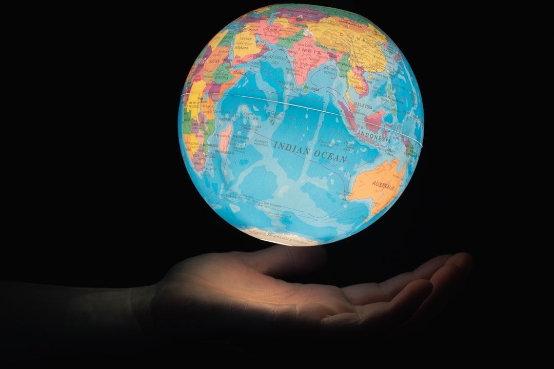 Global economy hologram rising from glowing microchip, diverse professionals analyzing AI financial data, sleek glass office, cool blue ambient lighting, futuristic