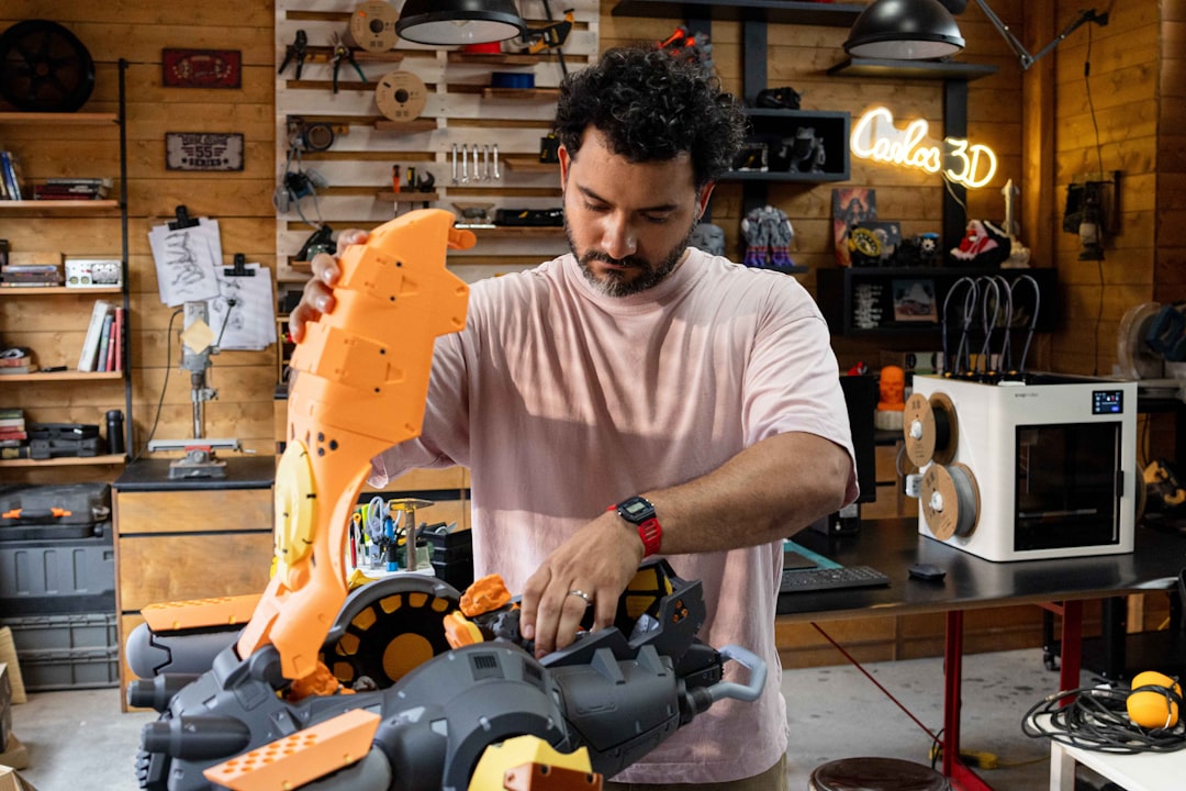Frustrated engineer dismantling complex robotics arm in bright clean workshop, discarded AI blueprints on table, natural window light contrasting with red failure indicators