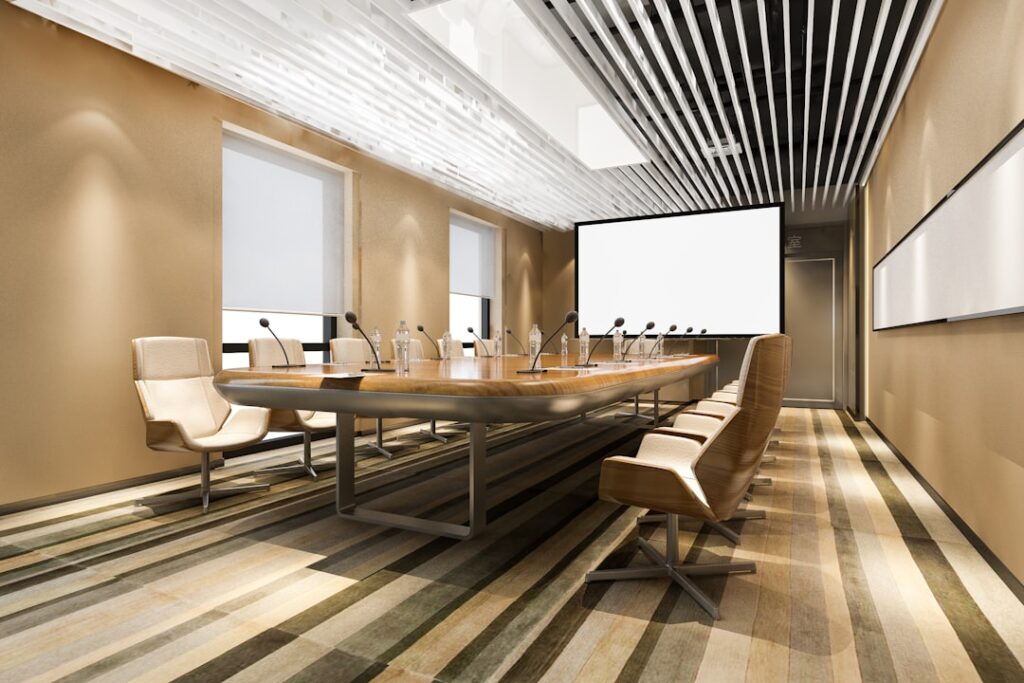 Futuristic corporate boardroom split by holographic divide, one side sleek modern office other side dark empty space, ambient blue lighting, human silhouettes facing AI neural network visualization, c