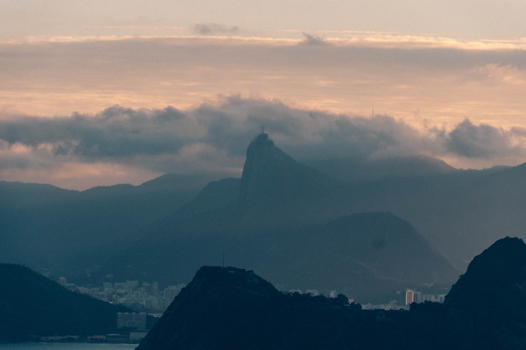 Futuristic Brazilian spaceport at twilight, holographic AI interface projecting neural network over tropical landscape, sleek professional observing data, warm ambient tech glow