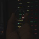 Futuristic holographic data visualization of trillion-dollar investment flows, sleek ambient lighting, professional analyst in clean modern office, neural network overlay, cool blue tones