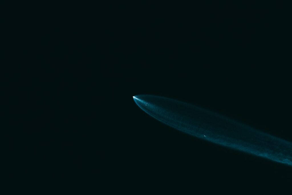Close-up of elegant vintage fountain pen dissolving into glowing blue neural network nodes, dark background with cinematic ambient lighting, symbolizing evolution from traditional writing to AI genera