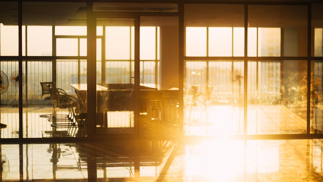 Brazilian professional shaking hands with translucent AI hologram in sunlit modern office, soft golden hour light, microchip detail overlay, hopeful mood of established digital trust and human-technol