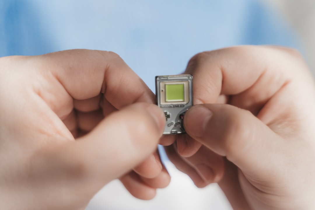 Futuristic microchip with integrated cooling channels glowing green, scientist hands holding transparent tablet showing renewable energy metrics, clean laboratory environment, hopeful ambient lighting