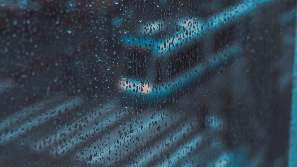 Futuristic data center with glowing server racks reflected in water droplets, cool blue ambient lighting, holographic water consumption metrics, professional tech environment, sleek modern aesthetic