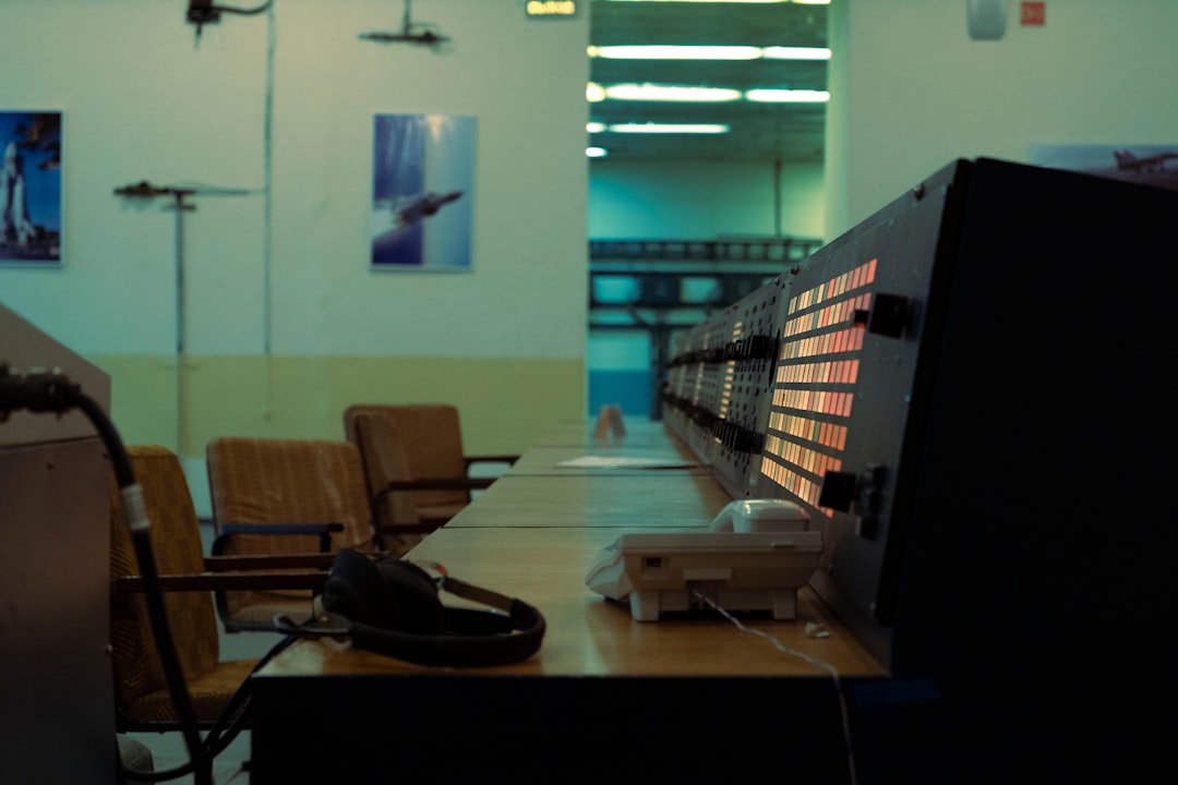 Vintage computing room with retro terminal screens transitioning to modern holographic AI interface, warm amber and cool blue ambient lighting, human silhouette observing evolution of machine intellig