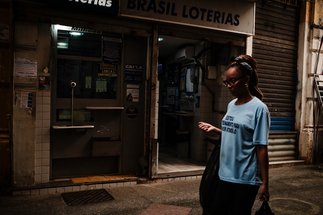 Professional Brazilian tech entrepreneur presenting at local startup hub, holographic business analytics floating between modern glass architecture and traditional city elements, golden hour ambient l